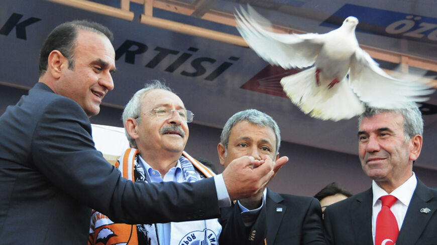 Kemal Kilicdaroglu (2nd L), leader of the main opposition Republican People's Party (CHP), releases a dove during an election rally in Adana, southern Turkey, March 27, 2014. Turkey's main opposition party has barely dented support for Prime Minister Tayyip Erdogan despite months of anti-government protests, an investigation into government graft and hours of incriminating conversations leaked online. Kemal Kilicdaroglu, head of the Republican People's Party (CHP), at campaign rallies in more than 70 cities