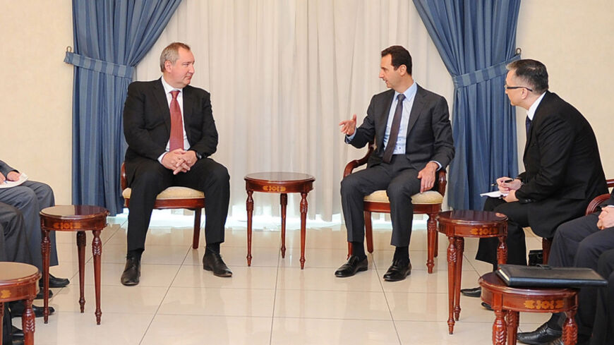 Syria's President Bashar al-Assad (center R) meets a Russian governmental delegation headed by deputy Prime Minister Dmitry Rogozin (center L), in Damascus, in this handout photograph distributed by Syria's national news agency SANA on May 24, 2014. REUTERS/SANA/Handout via Reuters (SYRIA - Tags: POLITICS CONFLICT CIVIL UNREST) ATTENTION EDITORS - THIS PICTURE WAS PROVIDED BY A THIRD PARTY. REUTERS IS UNABLE TO INDEPENDENTLY VERIFY THE AUTHENTICITY, CONTENT, LOCATION OR DATE OF THIS IMAGE. THIS PICTURE IS D