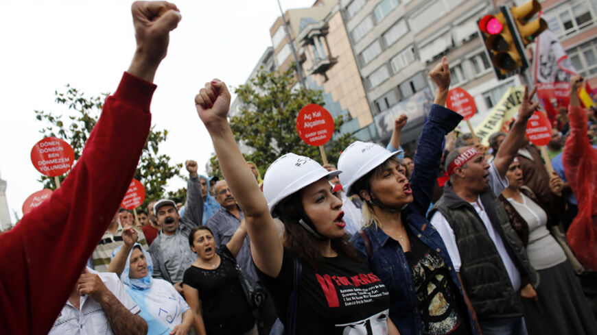Alevi demonstrators shout anti-goverment slogans during a protests against the latest violence in Okmeydani, a working-class district in the center of the city, in Istanbul May 25, 2014. Two people died last week after clashes between Turkish police and protesters in Okmeydani, a working-class district of Istanbul, stirring fears of further unrest as the anniversary of last year's anti-government demonstrations approaches. Okmeydani is home to a community of Alevis, a religious minority in mainly Sunni Musl