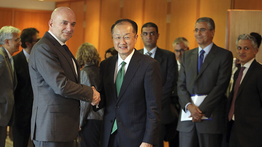 World Bank President Jim Yong Kim shakes hands with Lebanon's Minister of Economy and Trade Allan Hakim (L) upon his arrival at Beirut international airport June 2, 2014. REUTERS/Hasan Shaaban (LEBANON - Tags: POLITICS BUSINESS) - RTR3RVNB