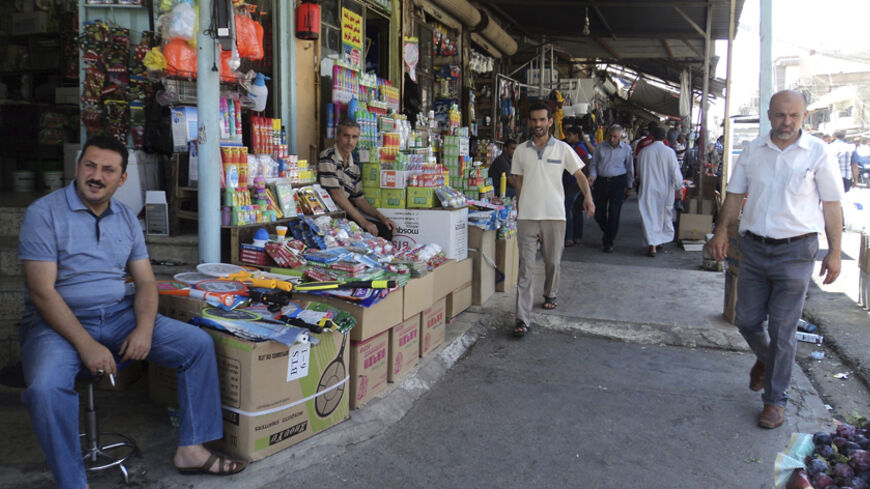 Residents shop at a market in the city of Mosul June 17, 2014. The United States is contemplating talks with its arch-enemy Iran to support the Iraqi government in its battle with Sunni Islamist insurgents who routed Baghdad's army and seized the north of the country in the past week.  Picture taken June 17, 2014. REUTERS/Stringer (IRAQ - Tags: CIVIL UNREST POLITICS SOCIETY TPX IMAGES OF THE DAY) - RTR3UL3P