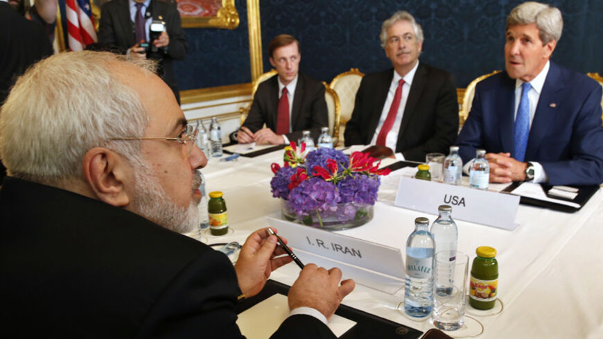 Iran's Foreign Minister Javad Zarif (L) holds a bilateral meeting with U.S. Secretary of State John Kerry (R) on the second straight day of talks over Tehran's nuclear program in Vienna, July 14, 2014. Kerry will press his Iranian counterpart Zarif to make "critical choices" in a second straight day of talks over Tehran's nuclear program on Monday, a U.S. official said.  REUTERS/Jim Bourg    (AUSTRIA - Tags: POLITICS ENERGY) - RTR3YJOV