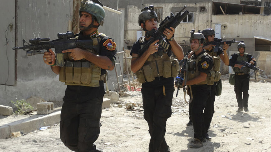 Members of the Iraqi Special Operations Forces (ISOF) conduct a patrol looking for militants of the Islamic State, formerly known as the Islamic State in Iraq and the Levant (ISIL), in a neighbourhood in Ramadi, July 22, 2014. Picture taken July 22, 2014. REUTERS/Osama Al-dulaimi (IRAQ - Tags: CIVIL UNREST POLITICS CONFLICT MILITARY) - RTR405S6