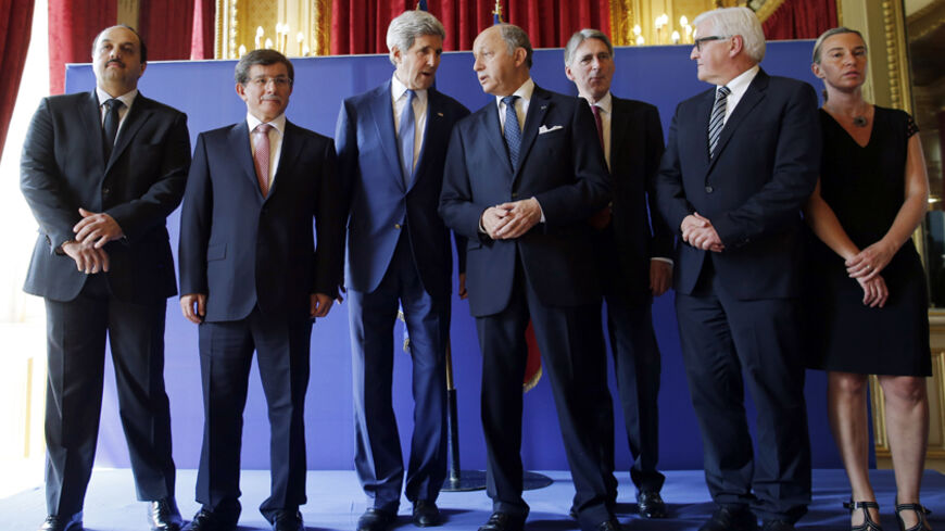U.S. Secretary of State John Kerry (3rd L) stands with (L-R) Qatari Foreign Minister Khaled al-Attiyah, Turkish Foreign Minister Ahmet Davutoglu, French Foreign Minister Laurent Fabius, British Foreign Secretary Philip Hammond, German Foreign Minister Frank-Walter Steinmeier and Italian Foreign Minister Federica Mogherini after their meeting regarding a ceasefire between Hamas and Israel in Gaza, at the foreign ministry in Paris, July 26, 2014. The foreign ministers on Saturday called for an extension of th