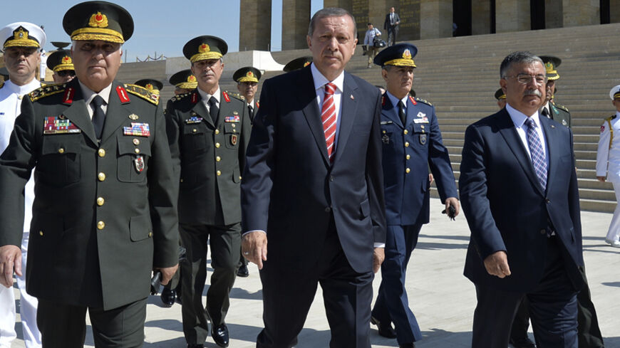 Turkey's Prime Minister Tayyip Erdogan (C), flanked by Chief of Staff General Necdet Ozel (L) and Defence Minister Ismet Yilmaz (R), leaves after a wreath-laying ceremony with members of the High Military Council at Anitkabir, the mausoleum of modern Turkey's founder Mustafa Kemal Ataturk, ahead of a High Military Council meeting in Ankara August 4, 2014. REUTERS/Stringer (TURKEY - Tags: POLITICS MILITARY ANNIVERSARY) - RTR415K3
