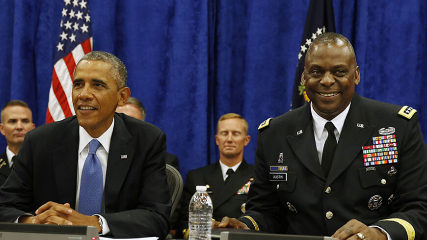 U.S. President Barack Obama sits next to Commander of Central Command Gen. Lloyd Austin III during in a briefing from top military leaders while at U.S. Central Command at MacDill Air Force Base in Tampa, Florida, September 17, 2014.      REUTERS/Larry Downing   (UNITED STATES - Tags: POLITICS MILITARY) - RTR46LLA