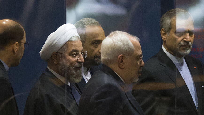 Iranian President Hassan Rouhani is surrounded by security while commuting to meetings on the sidelines of the 69th United Nations General Assembly at the United Nations Headquarters in New York, September 25, 2014. Rouhani blamed the rise of violent extremism on "certain states" and on unidentified "intelligence agencies" and said it was up to the region to find a solution to the problem. REUTERS/Adrees Latif  (UNITED STATES - Tags: POLITICS) - RTR47PL1