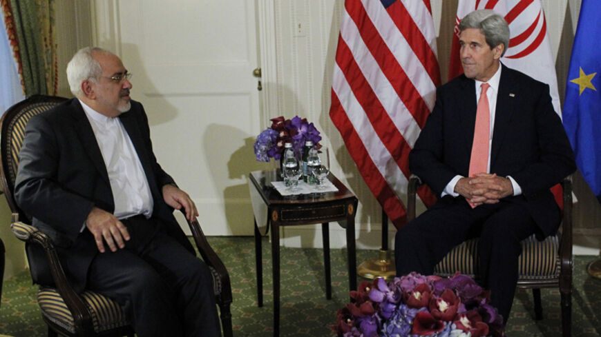 U.S. Secretary of State John Kerry (R) and Iranian Foreign Minister Mohammad Javad Zarif participate in a trilateral meeting at the Waldorf Astoria hotel in New York September 25, 2014. REUTERS/Eduardo Munoz (UNITED STATES - Tags: POLITICS) - RTR47QH5