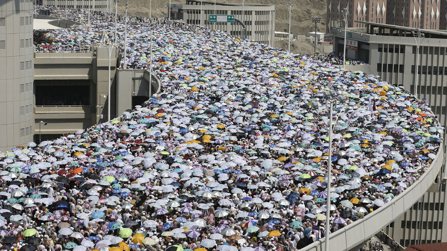 Muslim pilgrims walk on a bridge as they head to cast stones at pillars symbolizing Satan during the final day of the annual haj pilgrimage in Mina on the third day of Eid al-Adha, near the holy city of Mecca, October 6, 2014. Muslims around the world celebrate Eid al-Adha to mark the end of the haj pilgrimage by slaughtering sheep, goats, camels and cows to commemorate Prophet Abraham's willingness to sacrifice his son, Ismail, on God's command. REUTERS/Muhammad Hamed (SAUDI ARABIA - Tags: RELIGION) - RTR4