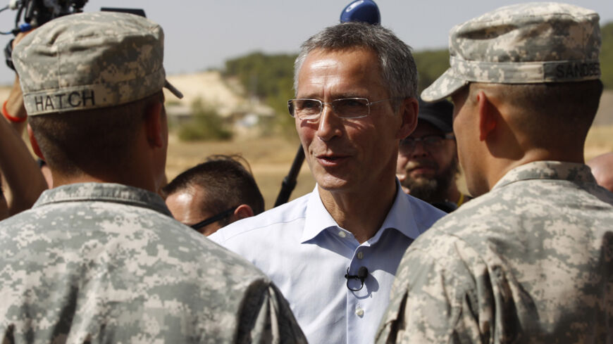 NATO Secretary-General Jens Stoltenberg (C) of Norway meets with U.S. soldiers during his visit to view the U.S. Patriot missile system at a Turkish military base in Gaziantep, southeastern Turkey, October 10, 2014. REUTERS/Osman Orsal (TURKEY - Tags: POLITICS MILITARY) - RTR49NYY