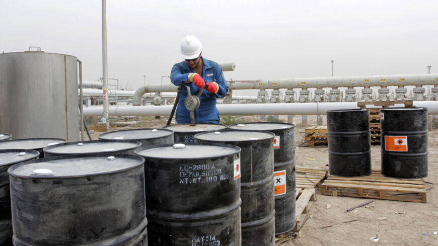A man works at the West Qurna oilfield in southern Basra October 13, 2014. Oil prices are hovering just above $90 per barrel, a level last seen in June 2012, putting a strong spotlight on OPEC producing countries.  They face calls to cut output at, or before,  a policy meeting in late November to prop prices up as some are already feeling the pinch of sub-$100 oil through increased budget pressure. Global oil prices are collectively reflecting the sweeping impact of a U.S. shale oil boom, with its productio