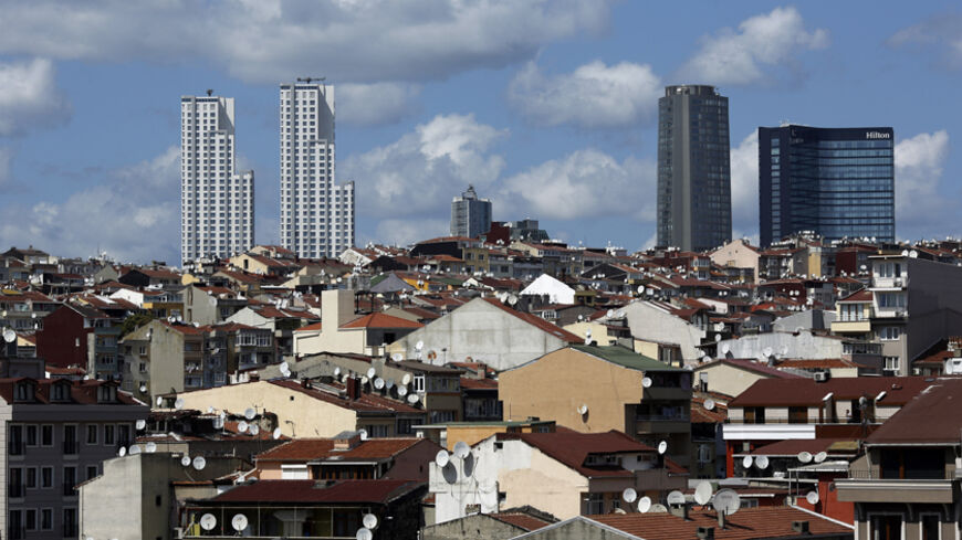 Skyscrapers are pictured behind old buildings in Beyoglu district in central Istanbul August 29, 2014. The Turkish Parliament amended the commercial code to allow landlords to eject tenants of 10 years or more without cause. The rule, which went into effect in July, scraps a tradition of renter-friendly laws, potentially hitting millions of businesses and residents. Picture taken August 29, 2014. To match TURKEY-GENTRIFICATION/ REUTERS/Murad Sezer (TURKEY - Tags: BUSINESS SOCIETY POLITICS CITYSCAPE) - RTR4B