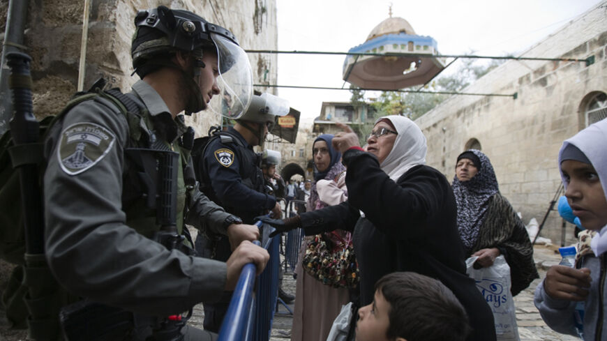 A Palestinian woman argues with an Israeli border police officer near the Lions Gate in the Old City of Jerusalem November 2, 2014. Israeli Prime Minister Benjamin Netanyahu on Saturday urged lawmakers to show restraint over Jerusalem's al-Aqsa mosque, which has been at the heart of rising tension with the Palestinians in recent weeks. Daily clashes between Israeli security forces and Palestinians in the streets of East Jerusalem and the al-Aqsa compound, known to Jews as the Temple Mount, have been stoking