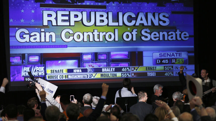 Republican supporters cheer as a giant TV screen displays the results of the Senate race in the U.S. midterm elections in Denver, Colorado, November 4, 2014.  REUTERS/Rick Wilking (UNITED STATES - Tags: POLITICS ELECTIONS) - RTR4CV3U