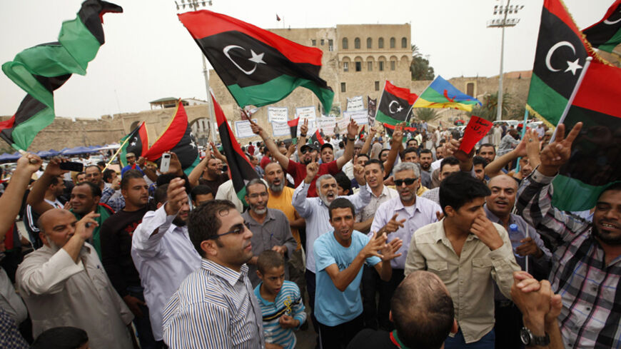 Libyans celebrate after the Supreme Court invalidated the country's parliament, at Martyrs' Square in Tripoli  November 6, 2014.  Libya's Supreme Court on Thursday declared the internationally recognised parliament as unconstitutional, in a ruling likely to fuel further chaos in the north African oil producing nation. The decision came a day after gunmen stormed Libya's biggest oilfield, shutting down production at the facility in the country's remote south in a new blow to the already beleaguered energy se