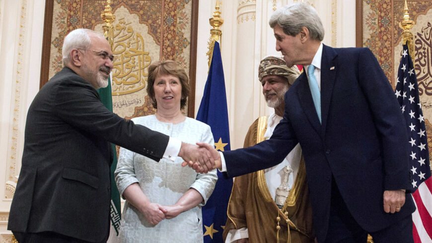 U.S. Secretary of State John Kerry (R) and Iranian Foreign Minister Mohammad Javad Zarif (L) shake hands as Omani Foreign Minister Yussef bin Alawi (2nd R) and EU envoy Catherine Ashton watch in Muscat November 9, 2014. Zarif began talks with Kerry and Ashton in Oman on Sunday to try to advance efforts to end a standoff over Tehran's nuclear program, a witness said. REUTERS/Nicholas Kamm/Pool (OMAN - Tags: POLITICS ENERGY) - RTR4DEJ8