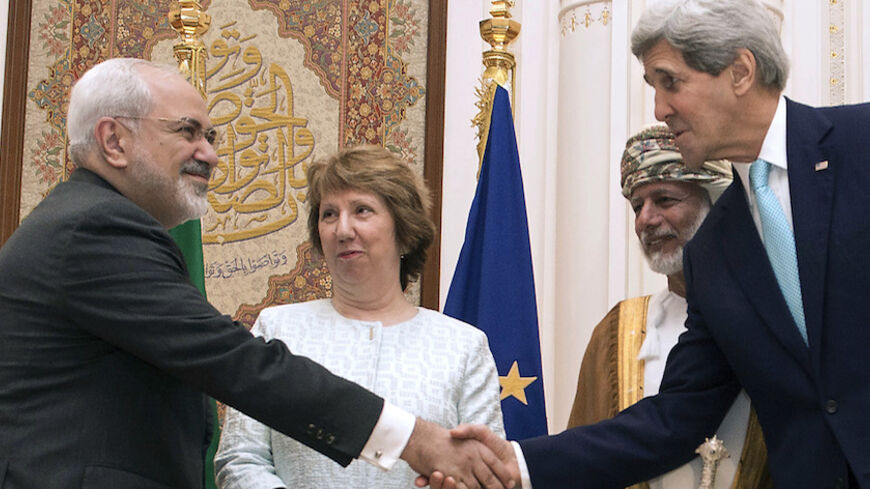 U.S. Secretary of State John Kerry (R) and Iranian Foreign Minister Javad Zarif (L) shake hands as Omani Foreign Minister Yussef bin Alawi (2nd R) and EU envoy Catherine Ashton watch in Muscat November 9, 2014. Zarif began talks with Kerry and Ashton in Oman on Sunday to try to advance efforts to end a standoff over Tehran's nuclear program, a witness said. REUTERS/Nicholas Kamm/Pool (OMAN - Tags: POLITICS ENERGY) - RTR4DEJL