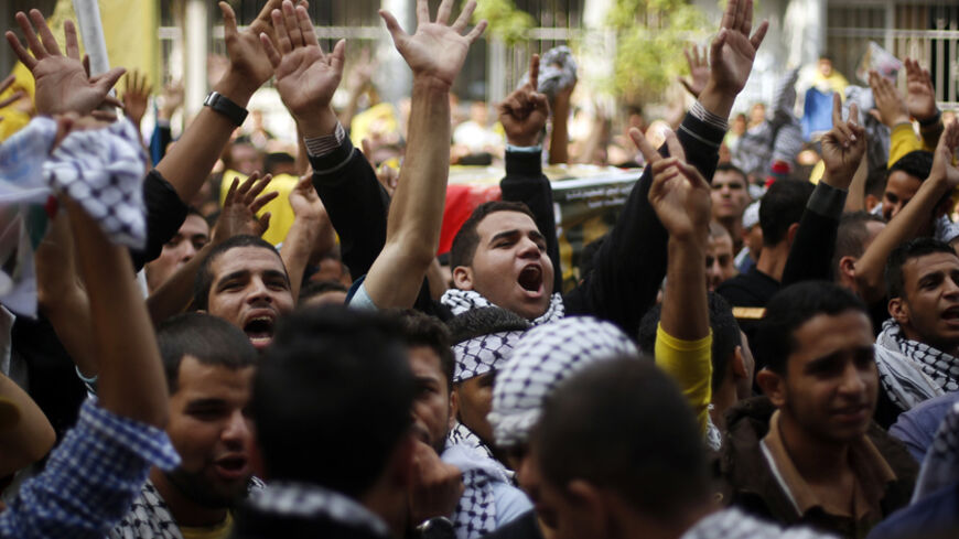 Palestinian Fatah supporters chant slogans as they take part in a rally marking the tenth anniversary of the death of late Palestinian leader Yasser Arafat, at Al-Azhar University in Gaza City November 11, 2014. Arafat died on November 11, 2004. REUTERS/Suhaib Salem (GAZA - Tags: POLITICS ANNIVERSARY OBITUARY) - RTR4DOUL