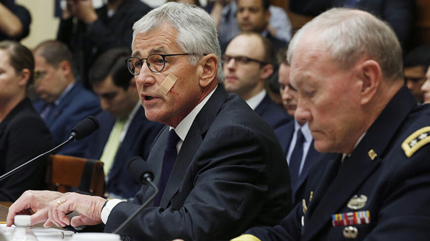 U.S. Secretary of Defense Chuck Hagel speaks next to Chairman of the Joint Chiefs, U.S. Army General Martin Dempsey during the House Armed Services Committee on Capitol Hill in Washington, November 13, 2014. REUTERS/Larry Downing (UNITED STATES - Tags: POLITICS MILITARY CONFLICT) - RTR4E1FT