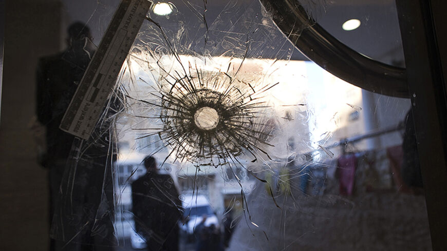 A bullet hole is seen in a door of a synagogue in Jerusalem where two Palestinian militants killed four rabbis and a policeman, November 19, 2014. Two Palestinians armed with a meat cleaver and a gun killed five people in the Jerusalem synagogue on Tuesday before being shot dead by police, the deadliest such incident in six years in the holy city. REUTERS/Ronen Zvulun (JERUSALEM - Tags: CIVIL UNREST POLITICS RELIGION TPX IMAGES OF THE DAY) - RTR4EP08