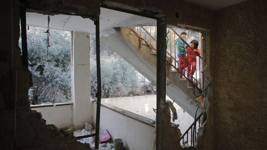 Palestinian girls, relatives of Abdel-Rahman Shaloudi stand on a staircase near his destroyed home in the East Jerusalem neighbourhood of Silwan November 19, 2014. Israel on Wednesday destroyed the home of a Palestinian, Shaloudi, who last month ran over and killed two people at a Jerusalem tram stop, a day after two militants killed four rabbis and a policeman at a synagogue in the city. REUTERS/Ammar Awad (JERUSALEM - Tags: POLITICS CIVIL UNREST TPX IMAGES OF THE DAY) - RTR4EPAJ