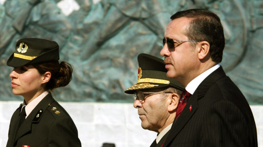 Turkish Prime Minister Tayyip Erdogan and Chief of Staff General Hilmi Ozkok are accompanied by a female officer as thek walk past Turkish memorial in Gallipoli.  Turkish Prime Minister Tayyip Erdogan (R) and Chief of Staff General Hilmi Ozkok are accompanied by a female officer as they walk past Turkish memorial in Gallipoli, in western Turkey, March 18, 2005. Turkey marked today the 90th anniversary of the World War One battle which Turkish forces defeated allied forces in Dardanelles straits in 1915, cla