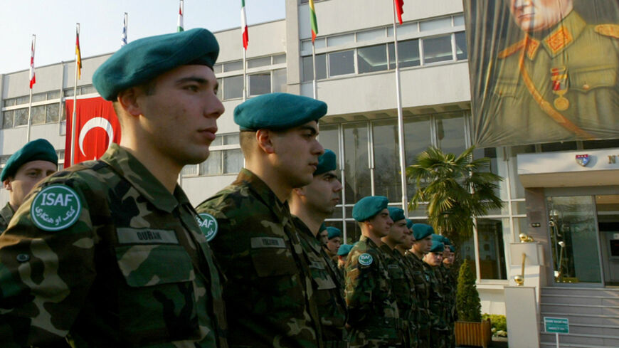 Turkish soldiers stand next to a portrait of Mustafa Kemal Ataturk, founder of modern Turkey, as they attend a farewell ceremony at the headquarters of the NATO Rapid Deployable Corps-Turkey (NRDC-T), Turkish 3rd Corps, in Istanbul January 11, 2005, on the eve of their departure to Afghanistan. Turkish 3rd Corps (NRDC-T) troops, who will start to deploy to Afghanistan on January 12, will take over the leadership of ISAF VII in Kabul between February and August 2005. REUTERS/Fatih Saribas  FS/MD - RTRK9J3