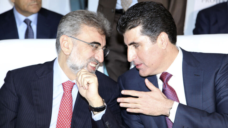 Iraq's Kurdistan Prime Minister Nechirvan Barzani (R) speaks with Turkey's Energy Minister Taner Yildiz (L) at the Iraq-Kurdistan Oil and Gas Conference at Arbil in Iraq's Kurdistan region, December 2, 2013. Turkey said on Monday it stood by a bilateral oil deal with Iraq's Kurdistan region that bypassed central government but wanted to win Baghdad's support by drawing it into the arrangement. Reuters reported that Turkey and Iraqi Kurdistan signed a multi-billion-dollar energy package last week, infuriatin