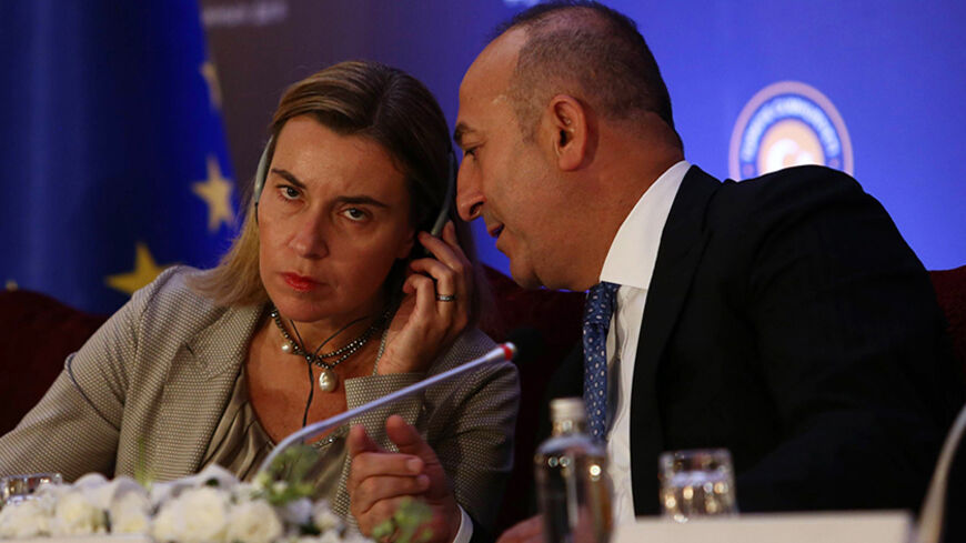 High Representative of the European Union for Foreign Affairs and Security Policy Federica Mogherini (L) and Turkish Foreign Minister Mevlut Cavusoglu (R) speak during a joint press conference after their meeting at the Ankara Palace on December 8, 2014. New European Union foreign policy chief Federica Mogherini was to meet Turkish leaders Monday for talks expected to focus partly on the war against the Islamic State insurgency in neighbouring Syria. AFP PHOTO/ADEM ALTAN        (Photo credit should read ADE
