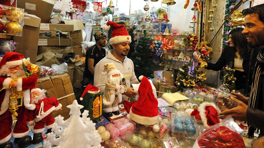 Iraqis shop for Christmas and New Year decorations and gifts at central Baghdad's Shorja market on December 20, 2014 in the lead up to the Christian religious festival celebrating the birth of Jesus Christ. AFP PHOTO / SABAH ARAR        (Photo credit should read SABAH ARAR/AFP/Getty Images)