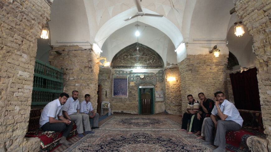 TO GO WITH STORY BY JOSEPH KRAUSS  Muslim men sit at the entrance of a mosque, housing the tombs of the four companions of the Jewish prophet Ezekiel in the little town of Kifl, south of Baghdad, on April 29 2009. Muslims revere nearly all the central religious figures from Judaism and Christianity, including Ezekiel -- the prophet who followed the Judeans into the Babylonian exile in the 6th century BC. Between 1948 and 1951 nearly all of Iraq's 2,500-year-old Jewish community fled amid a region-wide outbr