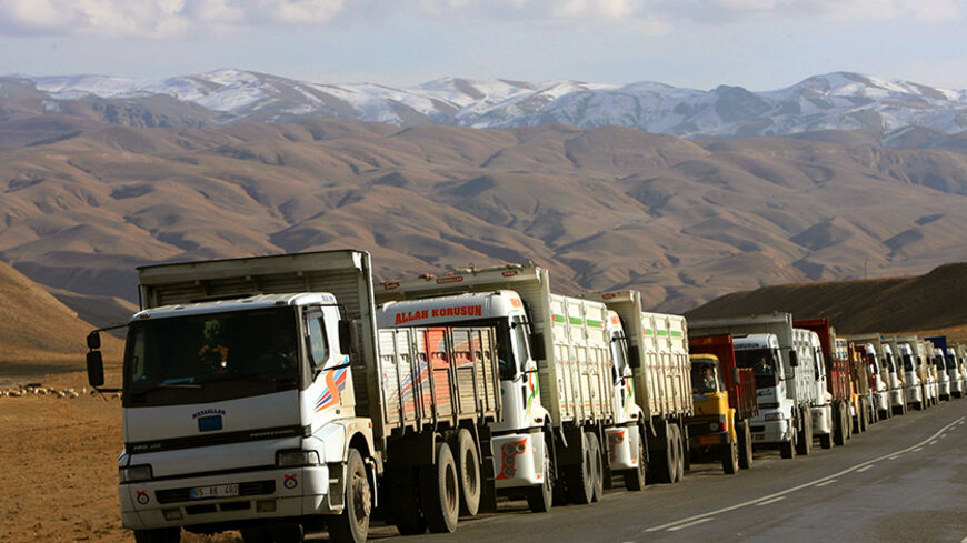 Hundreds of trucks bringing in diesel from Iran line up on a road as they head to the eastern province of Van in Turkey November 30, 2005. In the shadows of mountains bordering Iraq and Iran, Turkey's Hakkari province may one day be an outpost of the European Union. But for now, it feels cut off from the world. Picture taken November 30, 2005. To match feature Turkey-Southeast REUTERS/Fatih Saribas - RTR1AGOX