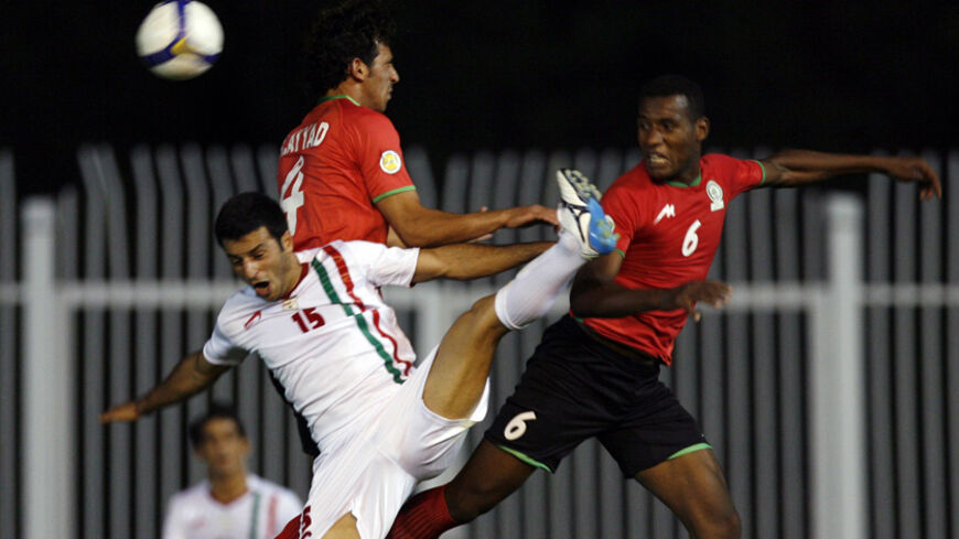 Iran's Ebrahim Sadeghisenjani (L) fights for the ball with Palestine's Rafat Ayyad (C) and Abdallatif Albahdari during their West Asian Championship soccer match in Tehran August 7, 2008. REUTERS/Fadi Al-Assaad (IRAN) - RTR20Q54