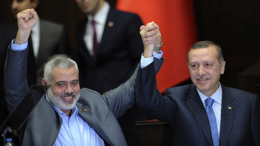 Turkey's Prime Minister Recep Tayyip Erdogan (R) and Hamas' Gaza leader Ismail Haniyeh greet members of parliament from Erdogan's ruling AK Party (AKP) during a meeting at the Turkish parliament in Ankara January 3, 2012. REUTERS/Stringer  (TURKEY - Tags: POLITICS) - RTR2VUBV