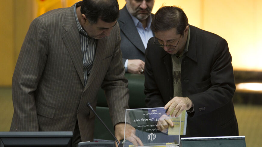 EDITORS' NOTE: Reuters and other foreign media are subject to Iranian restrictions on leaving the office to report, film or take pictures in Tehran.

Parliamentarians look at Iranian President Mahmoud Ahmadinejad's proposed budget in Tehran February 1, 2012. REUTERS/Morteza Nikoubazl (IRAN - Tags: POLITICS) - RTR2X5D4