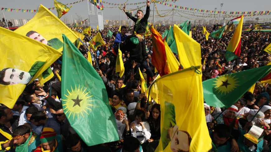 Demonstrators hold Kurdish flags and portraits of jailed Kurdistan Workers Party (PKK) leader Abdullah Ocalan during a gathering to celebrate Newroz in the southeastern Turkish city of Diyarbakir March 21, 2013. Jailed Kurdish rebel leader Abdullah Ocalan ordered his fighters on Thursday to cease fire and withdraw from Turkish soil as a step to ending a conflict that has killed 40,000 people, riven the country and battered its economy. Hundreds of thousands of Kurds gathered in the regional centre of Diyarb