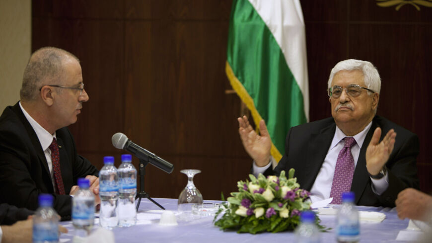 Palestinian President Mahmoud Abbas (R) meets with Palestinian Prime Minister Rami Hamdallah and ministers of the unity government, in the West Bank city of Ramallah June 2, 2014. Abbas swore in a Palestinian unity government on Monday under a reconciliation deal with Hamas Islamists that led Israel to freeze U.S.-brokered peace talks with the Western-backed leader. REUTERS/Majdi Mohammed/Pool (WEST BANK - Tags: POLITICS) - RTR3RU64