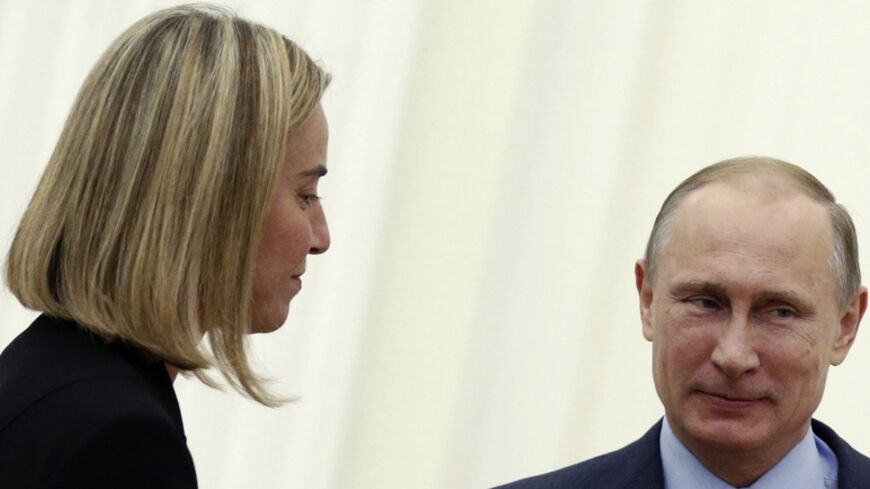 Russian President Vladimir Putin (R) meets with Italy's Minister of Foreign Affairs Federica Mogherini at the Kremlin in Moscow July 9, 2014. REUTERS/Maxim Shipenkov/Pool (RUSSIA  - Tags: POLITICS) - RTR3XUXK