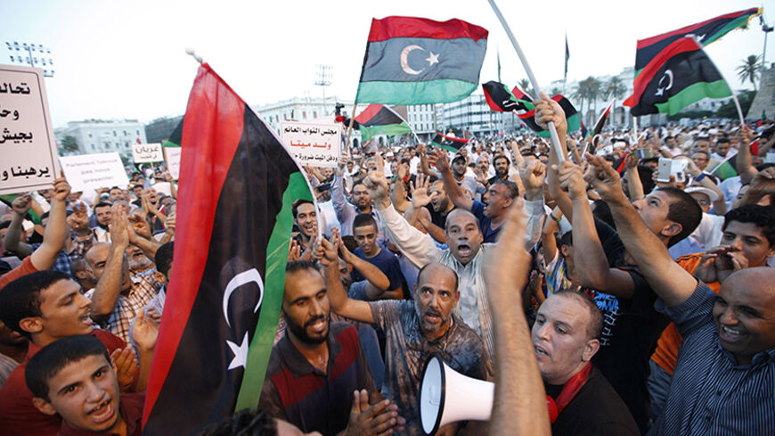 Supporters of Operation Dawn, a group of forces mainly from Misrata, demonstrate against and call for the removal of the new Libyan parliament based in the eastern city of Tobruk, the House of Representatives, at Martyrs' Square in Tripoli September 19, 2014. REUTERS/Ismail Zitouny (LIBYA - Tags: POLITICS CIVIL UNREST) - RTR46ZP8