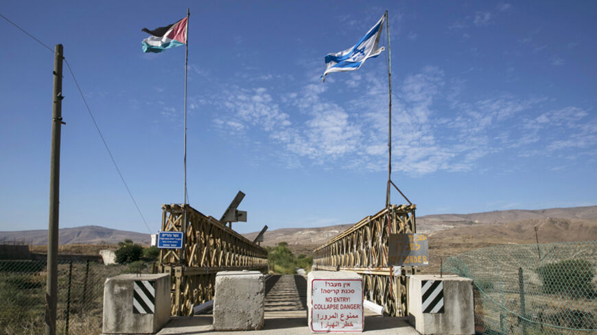 National Jordanian and Israeli flags are seen on the Naharayim bridge on the border between Israel and Jordan north-eastern Israel October 22, 2014. With attacks by Hezbollah from Lebanon, the threat from Islamic State and the Nusra Front in Syria and growing unrest in Egypt's Sinai, the north and south of Israel?s borders are on edge. By comparison, the eastern frontier with Jordan looks like an oasis of calm. Yet the Hashemite kingdom, wedged between Iraq, Syria and Saudi Arabia as well as Israel and the 