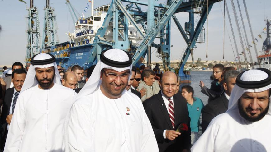 Suez Canal Authority Chairman Lieutenant General Mohab Mamish (2nd R) walks with a UAE delegation during a ceremony marking the start of dredging works on the New Suez Canal Project near the Suez Canal in Ismailia city November 13, 2014. The project is led by the National Marine Dredging Company of the Emirates in collaboration with the Suez Canal Authority. REUTERS/Asmaa Waguih (EGYPT - Tags: POLITICS TRANSPORT MARITIME) - RTR4E2KF