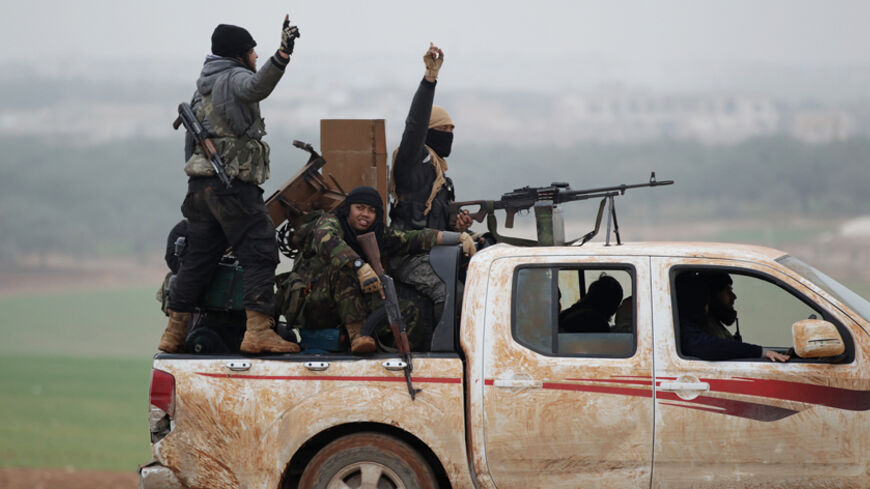 Members of al Qaeda's Nusra Front gesture as they drive in a convoy touring villages, which they said they have seized control of from Syrian rebel factions, in the southern countryside of Idlib, December 2, 2014. Picture taken December 2, 2014. 
REUTERS/Khalil Ashawi (SYRIA - Tags: CIVIL UNREST CONFLICT) - RTR4GJ0L