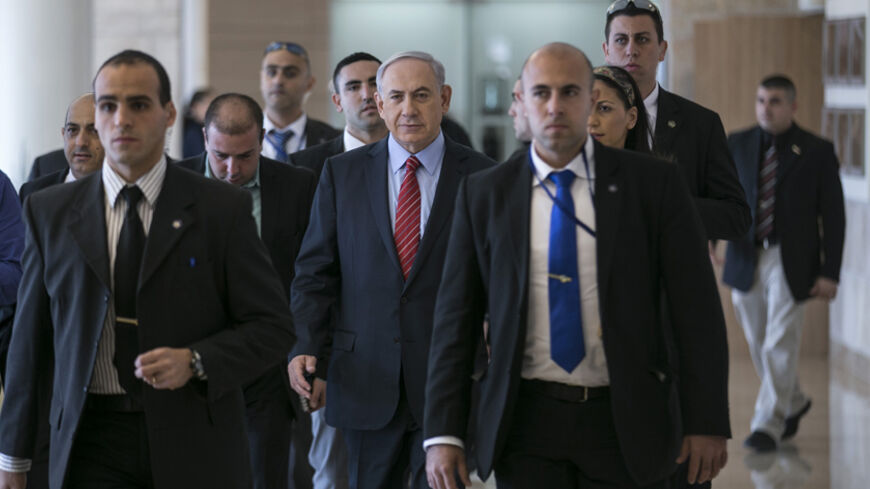 Israeli Prime Minister Benjamin Netanyahu (C) arrives to a Likud party meeting at the parliament in Jerusalem December 3, 2014. Israeli legislators agreed in a preliminary vote on Wednesday to dissolve parliament, and they set March 17 as the date for a new parliamentary election after Prime Minister Benjamin Netanyahu fired two centrist cabinet members and declared an early national ballot. According to opinion polls, Netanyahu, whose current government took office only two years ago, is on course to win a