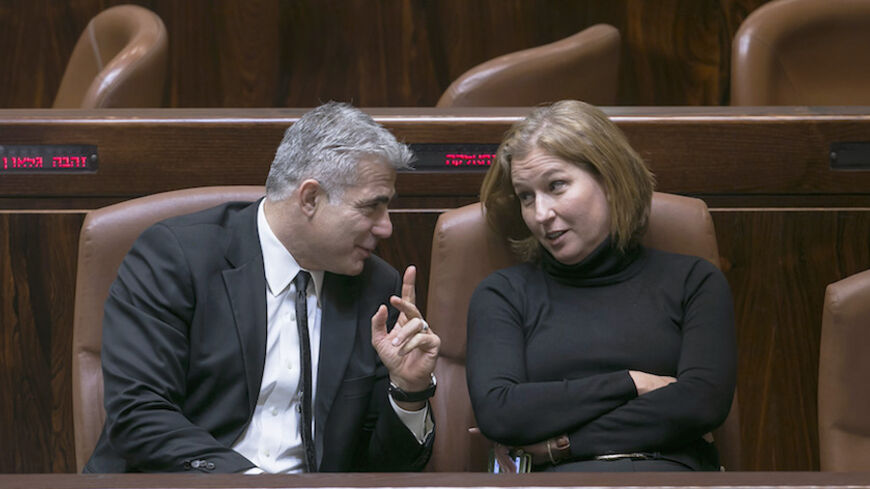 Israel's dismissed Finance Minister Yair Lapid and Justice Minister Tzipi Livni talk after a vote to dissolve parliament of the Knesset, the Israeli parliament, in Jerusalem December 3, 2014. Israeli legislators agreed in a preliminary vote on Wednesday to dissolve parliament, and they set March 17 as the date for a new parliamentary election after Prime Minister Benjamin Netanyahu fired two centrist cabinet members and declared an early national ballot. According to opinion polls, Netanyahu, whose current 