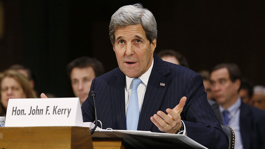 U.S. Secretary of State John Kerry testifies before a Senate Foreign Relations Committee hearing on "Authorization for the Use of Military Force Against ISIL" on Capitol Hill in Washington December 9, 2014. REUTERS/Yuri Gripas (UNITED STATES - Tags: POLITICS CIVIL UNREST CONFLICT) - RTR4HCK4