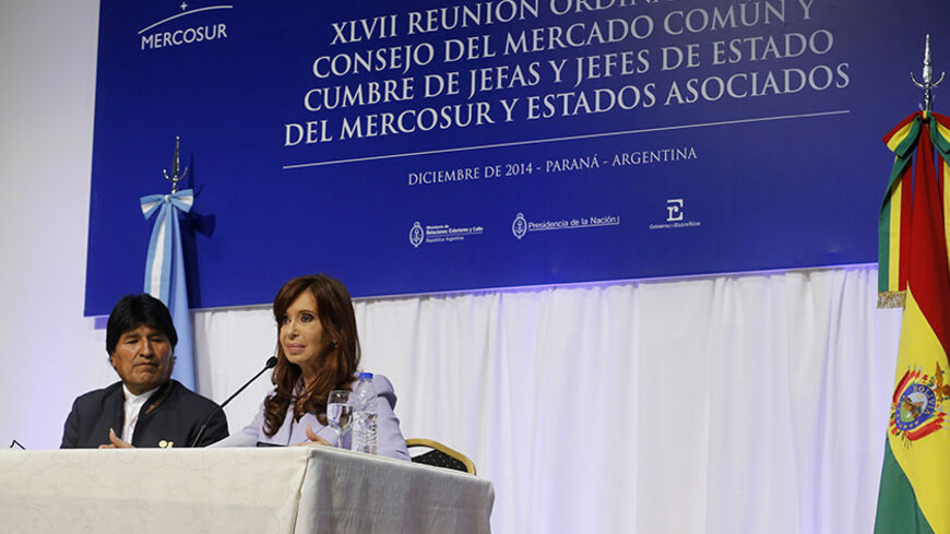 Bolivia's President Evo Morales (L) and his Argentine counterpart Cristina Fernandez de Kirchner attend a bilateral meeting after the Southern Common Market (MERCOSUR) trade bloc annual presidential 47th summit in Parana, north of Buenos Aires December 17, 2014. Argentina and Bolivia signed a commercial agreement on Argentine-assembled ambulances to be delivered to Bolivia.   REUTERS/Enrique Marcarian (ARGENTINA - Tags: POLITICS) - RTR4IH3O