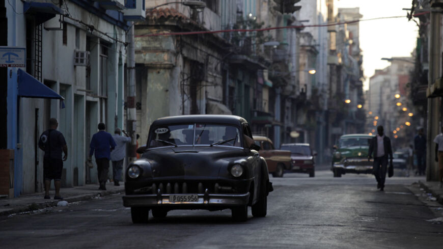 A car used as a taxi drives through the streets of Havana December 19, 2014. With Washington agreeing to restore full diplomatic ties that were cut in the early 1960s, Cuba's communist government may not be able to blame its old Cold War nemesis so readily. Cuba has repeatedly sought to dispel the idea that it secretly wanted the embargo in place, saying if the Americans believed that they should challenge Cuba by lifting it. REUTERS/Enrique De La Osa (CUBA - Tags: POLITICS SOCIETY) - RTR4IPO9