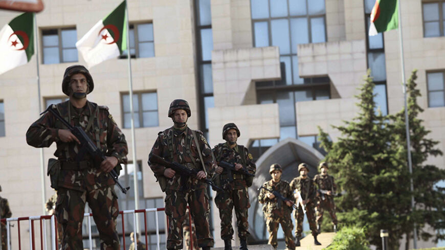 The Algerian Republican Guard is seen in front of the Presidential Palace in Algiers October 16, 2014. Algeria's government has reached a deal to end a three-day protest by police officers who had staged a sit-in outside President Abdelaziz Bouteflika's office demanding better working conditions, Prime Minister Adelmalek Sellal said on Wednesday. "The government will meet next Sunday to address their demands, particularly the finance related ones," Sellal told state television after meeting with a delegatio
