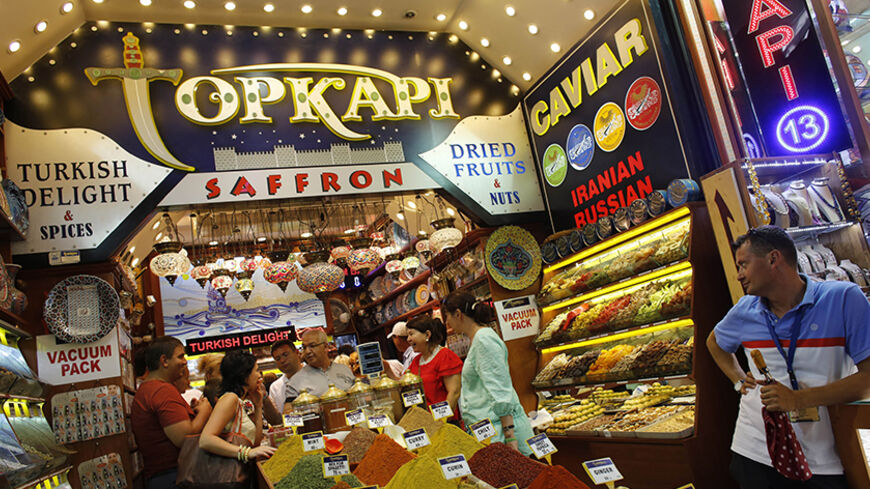 Tourists from Kazakhstan and Russia shop at a store at the Spice market, also known as the Egyptian Bazaar, in Istanbul August 23, 2013. The number of foreign visitors arriving in Turkey grew at its slowest pace for eight months in July, as the impact of anti-government protests and the Muslim fasting month of Ramadan took their toll, data showed on Friday. Foreign arrivals rose 0.48 percent year-on-year last month to 4.59 million people, according to the Tourism Ministry figures, the lowest rise since Nove