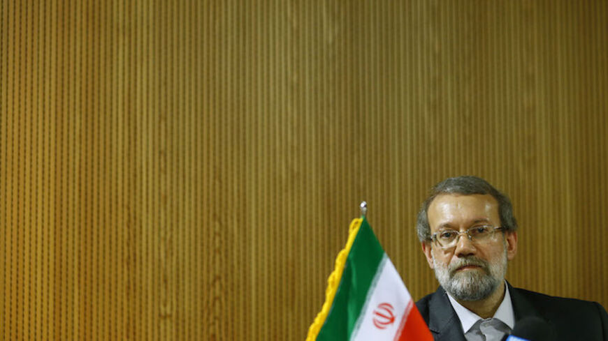 Ali Larijani, Speaker of the Iranian Parliament, pauses during a news conference after the 129th Assembly of the Inter-Parliamentary Union in Geneva October 9, 2013.  REUTERS/Denis Balibouse (SWITZERLAND - Tags: POLITICS) - RTX144ML